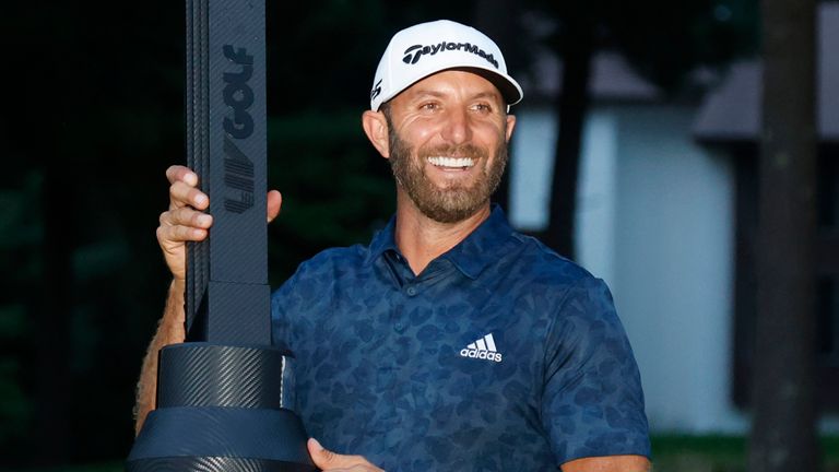 Dustin Johnson celebrates with the trophy after winning the LIV Golf Invitational-Boston tournament in a playoff