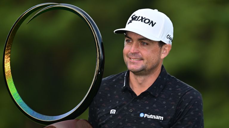 Bradley poses with the trophy in Japan after edging Rickie Fowler and Andrew Putnam by one shot