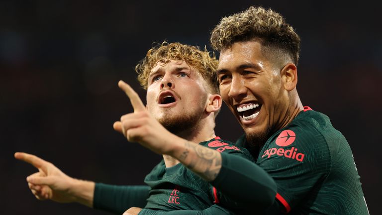 Harvey Elliott celebrates with Roberto Firmino after scoring Liverpool's third against Ajax