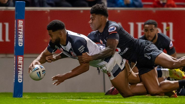 Kallum Watkins forced his way over for England despite Kevin Naiqama's best efforts
