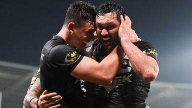 Jordan Rapana (right) celebrates scoring a late try to seal victory over Fiji
