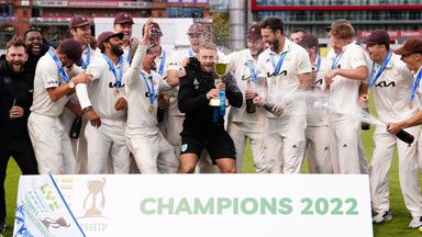 Surrey players celebrate with the trophy after winning the 2022 County Championship