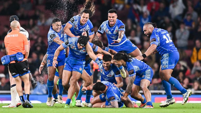 Stephen Crichton is mobbed by his team-mates after landing the game-winning drop goal for Samoa