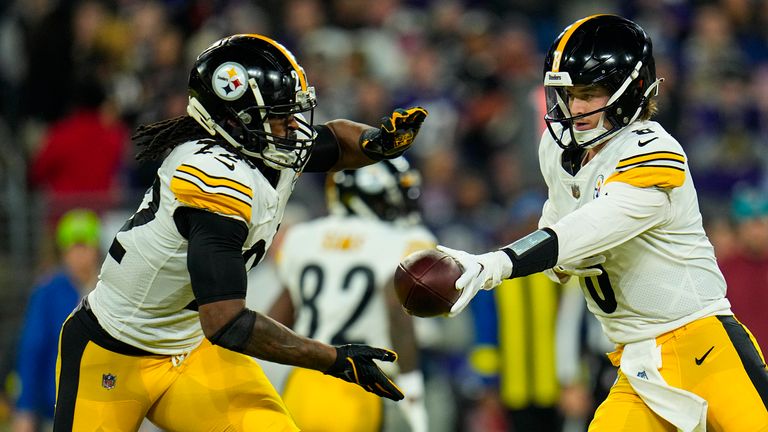 Pickett hands off to running back Harris (AP Photo/Julio Cortez)