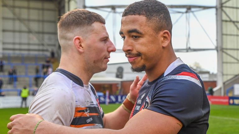 France's Tanguy Zenon is embraced by England captain George Williams at full-time