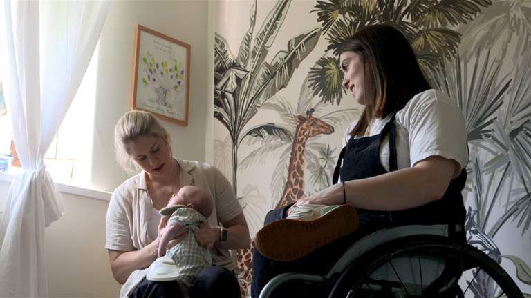 Paralympians Robyn Love and Laurie Williams share a tender moment with their daughter Alba