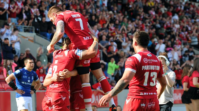 Salford's players celebrate scoring their fifth try