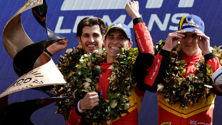 Ferrari AF Corse drivers Antonio Giovinazzi, left, Alessandro Pier Guidi, centre, from Italy, and James Calado from Britain celebrate their victory at the 24-hour Le Mans race