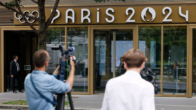 Reporters work outside the headquarters of the Paris Olympic organisers (AP Photo/Thomas Padilla)