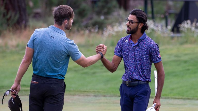 Akshay Bhatia shakes hands with Patrick Rodgers after winning the playoff