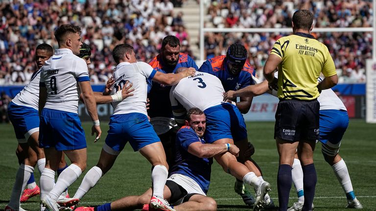 Italy's Simone Ferrari, right, is tackled by Namibian players 