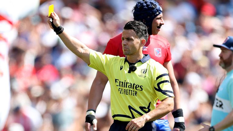 Referee Nic Berry shows a yellow card in the match between Japan and Chile