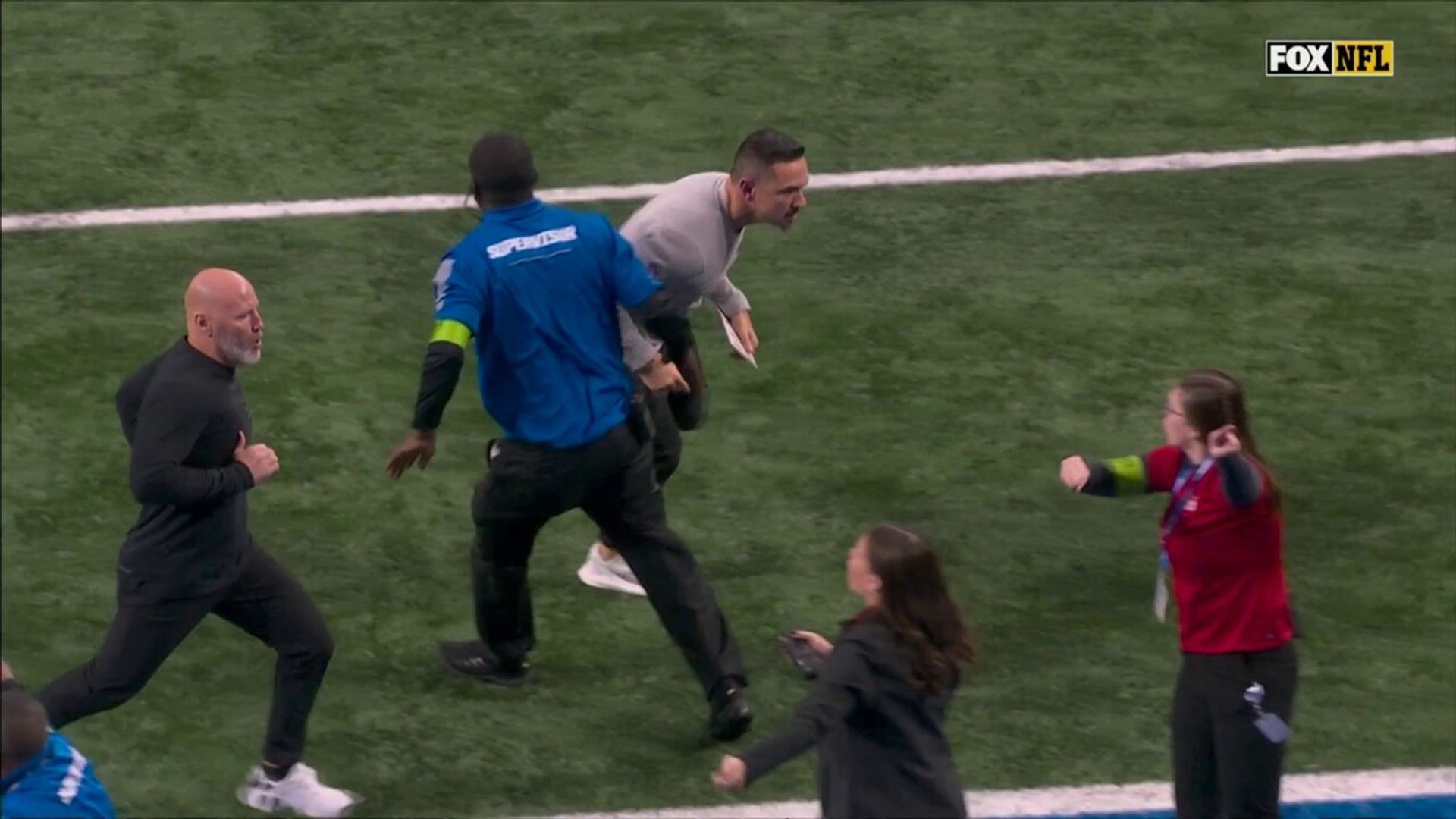 Block or charge? Packers coach LaFleur runs into security guard
