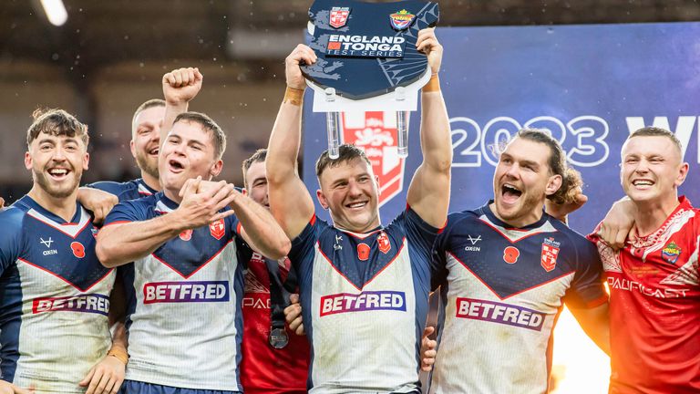 England captain George Williams celebrates with the series shield after the win over Tonga