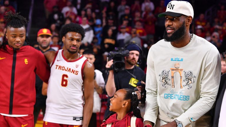 Lebron James and his daughter Zhuri Nova walk past Bronny James ahead of USC's clash with Long Beach State