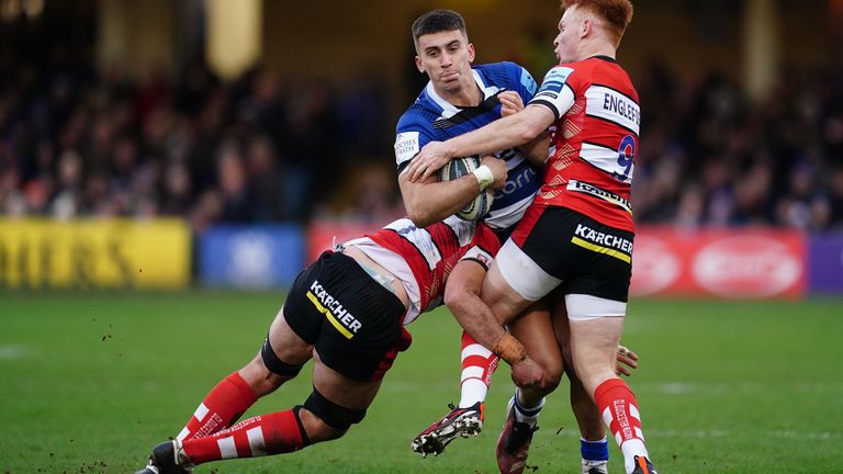 Bath's Cameron Redpath is tackled by Gloucester's Caolan Englefield