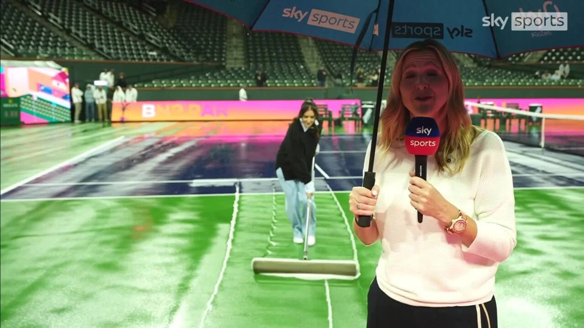 Robson helps sweep the court during rain delay!