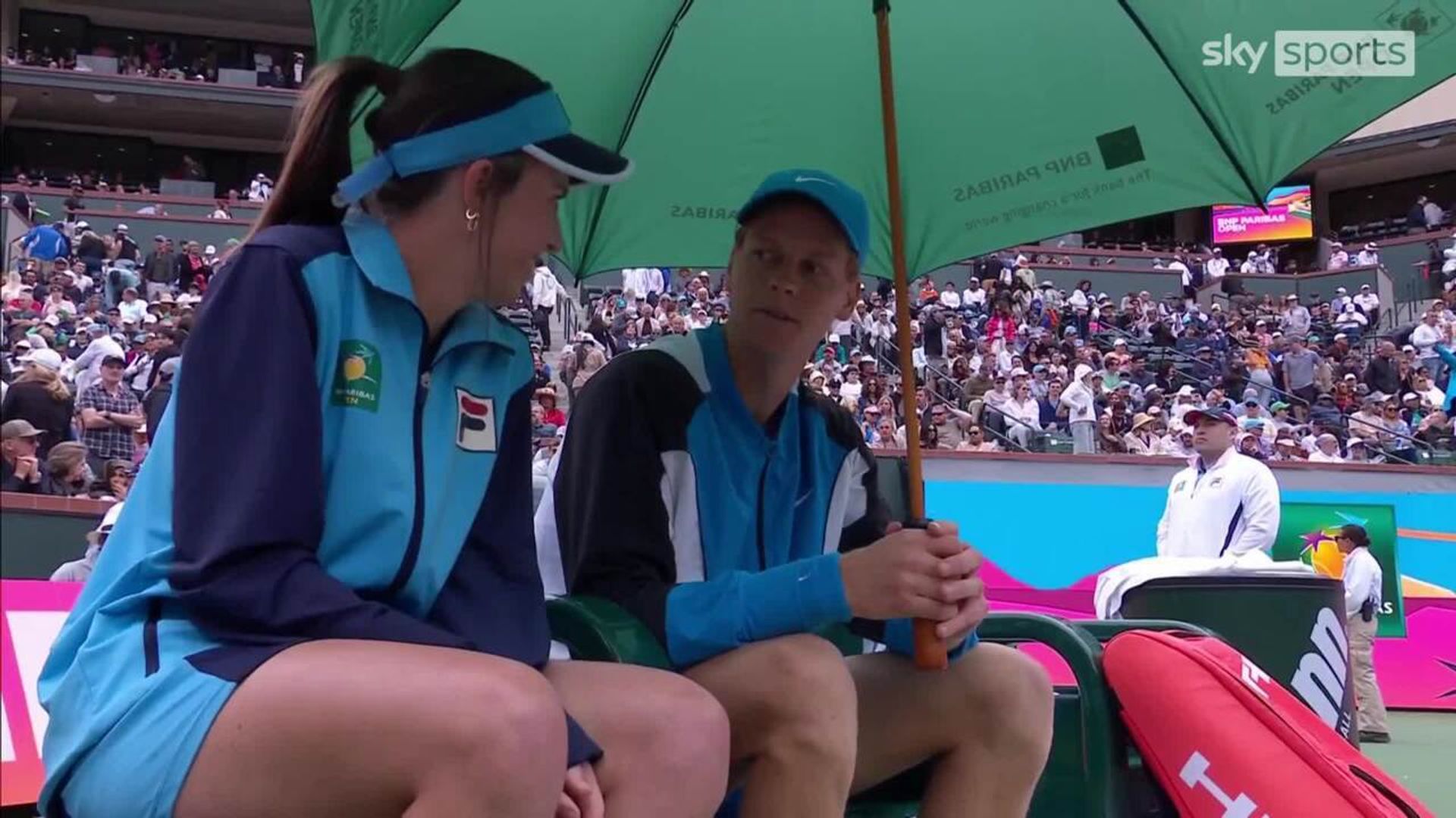 Sinner takes cover with ball kid during rain delay!