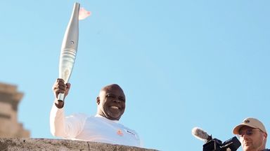 French torchbearer Basile Boli participates in the first stage of the Olympic torch relay in Marseille, southern France, Thursday, May 9, 2024. Torchbearers are to carry the Olympic flame through the streets of France' s southern port city of Marseil