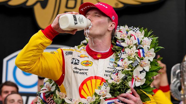 Newgarden celebrates with the traditional quart of milk after winning the Indy 500