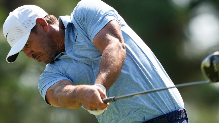 Koepka hits his tee shot on the 11th hole during the first round 