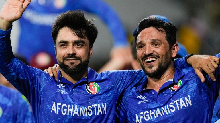 Afghanistan's captain Rashid Khan (left) and Gulbadin Naib celebrate after clinching at T20 World Cup semi-final spot