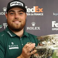 Dan Bradbury of England celebrates winning with the trophy at the FedEx Open de France 2024 at Le Golf National