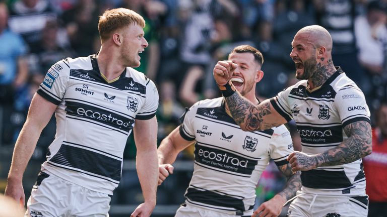 Harvey Barron (left) of Hull FC celebrates with Zak Hardaker and Cade Cust after scoring a try