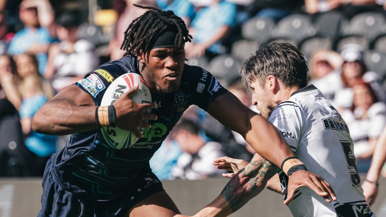 Junior Nsemba of Wigan is tackled by Tom Briscoe of Hull FC