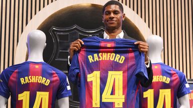 Marcus Rashford holds up his new No 14 shirt after joining Barcelona on loan from Manchester United