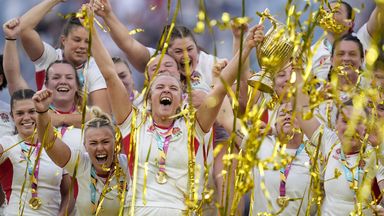 England's players celebrate as Zoe Aldcroft lifts the Women's Rugby World trophy