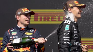 Mercedes driver George Russell, right, is sprayed with champagne by Red Bull's Max Verstappen after winning the Canadian Grand Prix in June