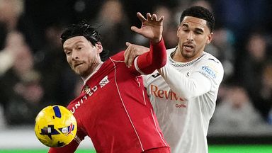 Wrexham's Kieffer Moore and Swansea City's Ben Cabango battle for the ball