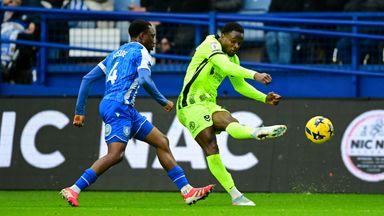 Millenic Alli of Portsmouth crosses the ball while under pressure from Sean Fusire of Sheffield Wednesday