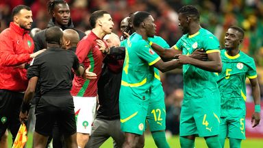 Senegal players (right) rage after a penalty is awarded to Morocco in stoppage time