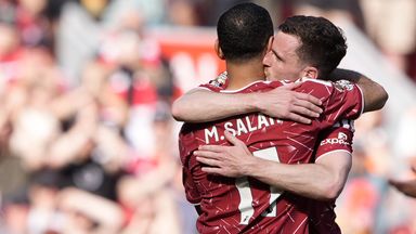 Mohamed Salah hugs Andy Robertson before leaving the field for the final time at Anfield