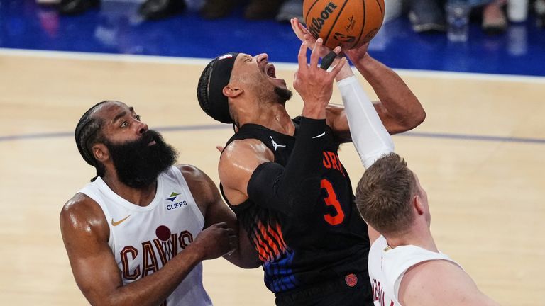 Cleveland Cavaliers' James Harden (left) and Sam Merrill defend Josh Hart