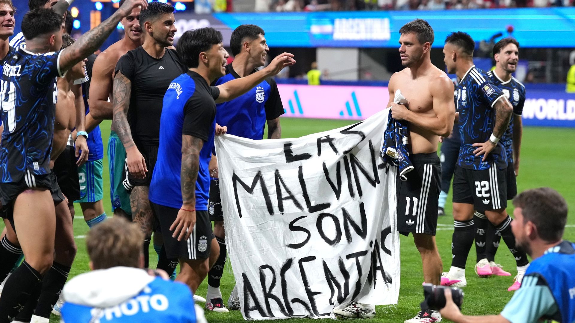Argentina players hold up Falklands Islands banner after win over England