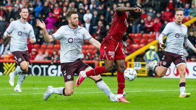 Hearts' Stuart Findlay (L) fouls Aberdeen's Toyosi Olusanya (R)