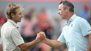 Paul Casey shakes hands with his playing partner Joakim Lagergren on the 18th hole