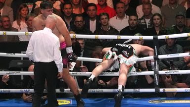 Carty falls through the ropes after receiving a blow to the back of the head from Allen
