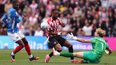 Cyle Larin of Southampton is challenged by Nicolas Schmid of Portsmouth