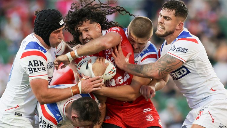 Tonga winger Dallin Watene-Zelezniak is tackled by Victor Radley, Harry Smith, Sam Walters and Brad O'Neill